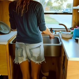 Hand washing dishes in an RV camper
