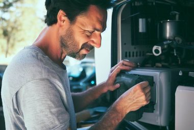 Man doing maintenance on RV Appliances