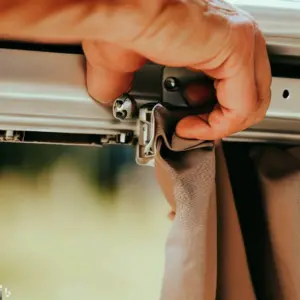 a hand Installing an RV awning - close up