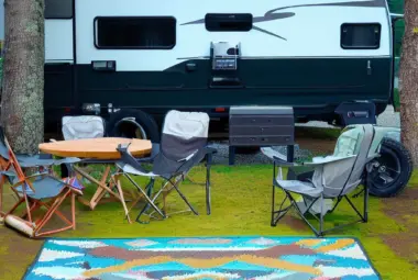 RV outdoor rug in front of a camper