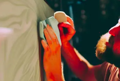 hands with microfiber rag waxing and RV detailing exterior of RV